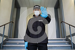 Security Guard In Face Mask Making Stop Gesture photo