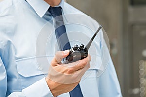 Security Guard Holding Walkie-talkie