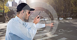 Security guard holding walkie talkie while pointing on road