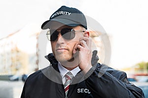 Security Guard Listening To Earpiece