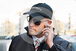 Security Guard Listening To Earpiece