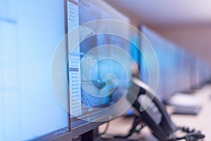 Security guard monitoring modern CCTV cameras in surveillance room