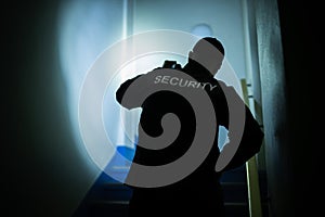 Security Guard Searching On Stairway