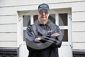 Security Guard Standing Arms Crossed Outside Building