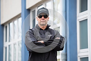 Security Guard Standing Arms Crossed Outside Building