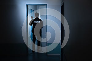 Security Guard Standing In Corridor Of Building