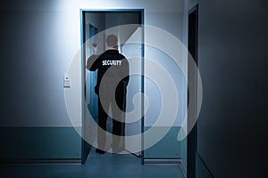 Security Guard Standing In Corridor Of Building