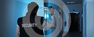 Security Guard Standing In Corridor Of The Building