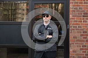 Security Guard Standing In Front Of The Entrance