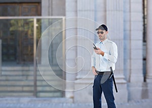 security guard with sun glasses and walkie-talkie guarding the door