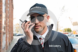 Security Guard Talking On Walkie-talkie photo