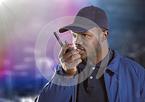 Security guard with walkie talkie against blurry wall with building sketch and flare