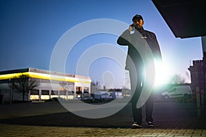 Security Guard Walking Building Perimeter With Flashlight