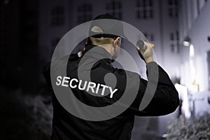 Security Guard Walking Building Perimeter photo