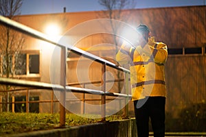 Security Guard Walking With Flashlight At Night