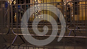 Security guardrail dividing road and pavement during public celebration in city