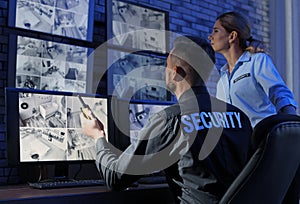 Security guards monitoring modern CCTV cameras photo