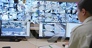 Security guards monitoring modern CCTV cameras in surveillance room