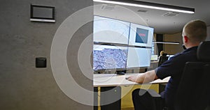 Security guards monitoring modern CCTV cameras in surveillance room