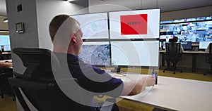 Security guards monitoring modern CCTV cameras in surveillance room