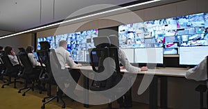 Security guards monitoring modern CCTV cameras in surveillance room