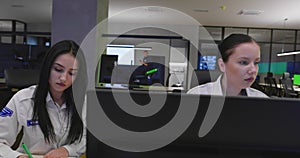 Security guards monitoring modern CCTV cameras in surveillance room