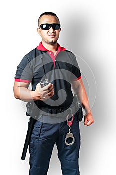 Security guards wear dark glasses. stand holding a radio There are rubber batons and handcuffs on the tactical belt. on isolated