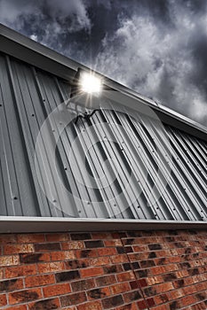 Security Light Mounted On A Factory Wall At Night