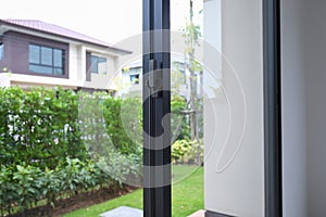 Security lock on glass window with green garden outside view