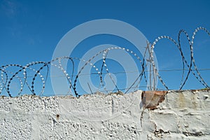Security measure on brick wall using razor wire