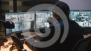 Security officer controls CCTV cameras on computer