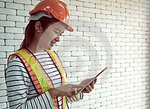 Security officer hold tablet and check the data with smiling