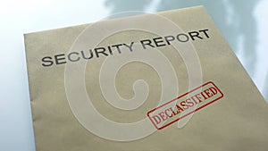 Security report declassified, seal stamped on folder with important documents photo