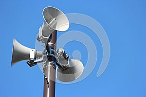 security speakers tower for warning or announce with clear blue sky background. photo