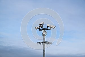 Security surveillance cameras on a post with spikes in England, UK