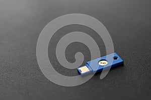 Security system concept. Key-shaped USB drive on dark background. Technology and data security theme.