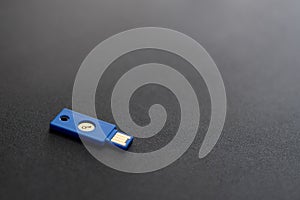 Security system concept. Key-shaped USB drive on dark background. Technology and data security theme.