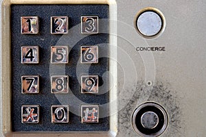 Security system - intercom on building with keypad and lock.