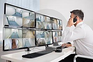 Security System Operator Looking At CCTV Footage photo