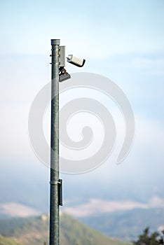 Security video camera against sky