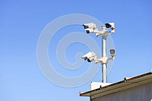 Security video camera against sky