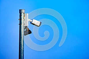 Security video camera against sky