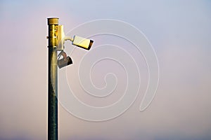 Security video camera against sky