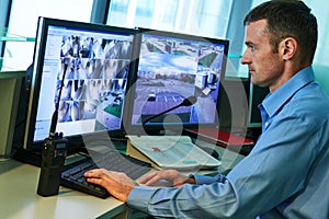 Security worker during monitoring. Video surveillance system.