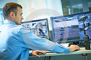 Security worker during monitoring. Video surveillance system.