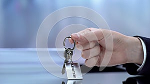 Security written on keychain male demonstrating, secrecy and safety concept