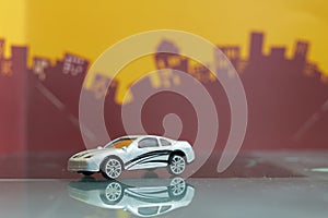 Sedan car toy selective focus on blur city background
