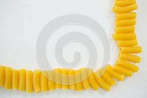 Sedani rigati pasta on arranged in a row