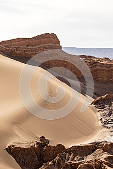 Sedimentary rocks in the dunes of the moon valley in the atacama desert