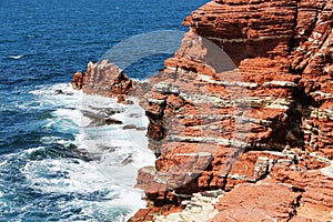 Sedimentary sea cliff, red rocks, from sicily